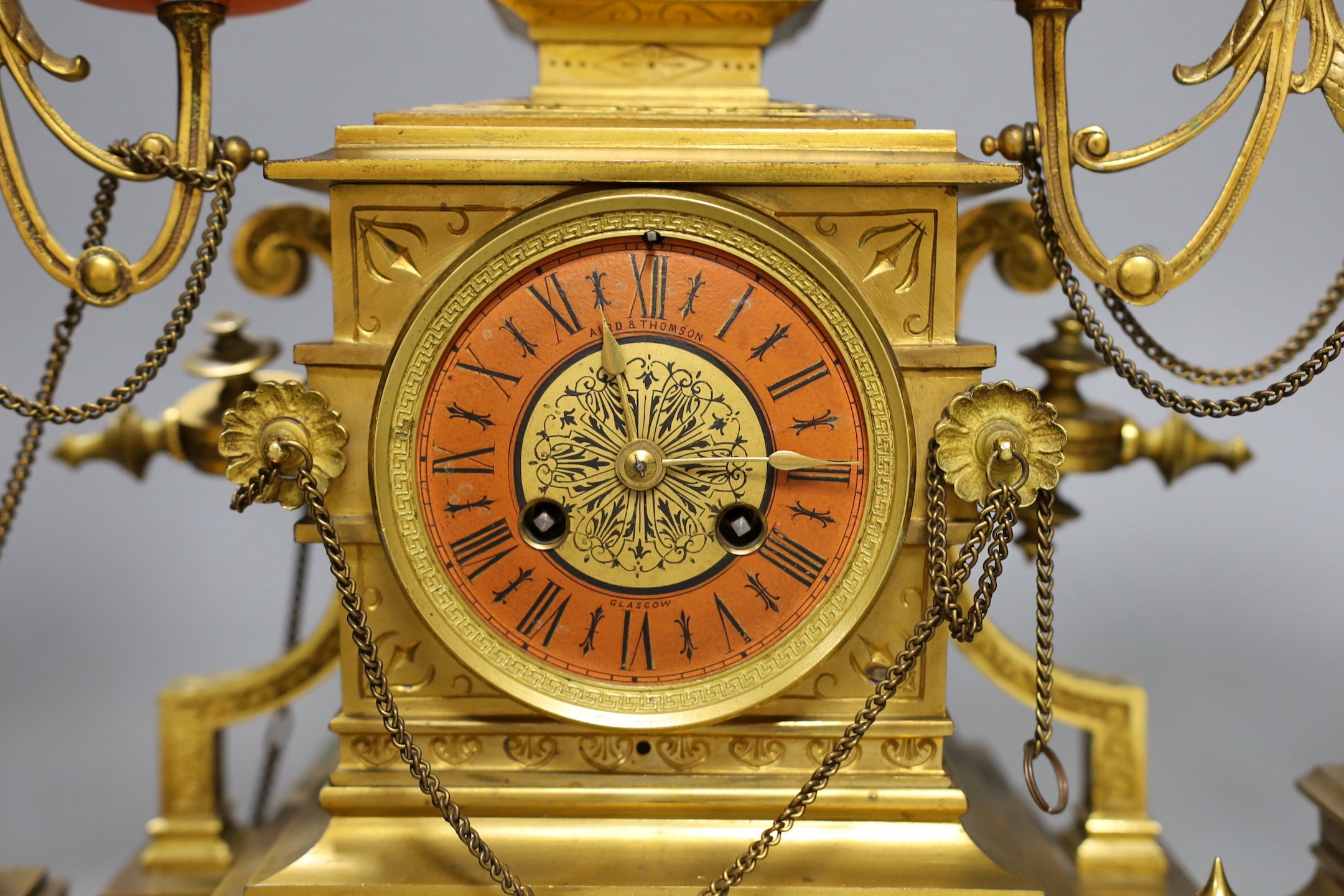 A late 19th century French Etruscan revival ormolu and porcelain mounted three piece clock garniture, 40cm